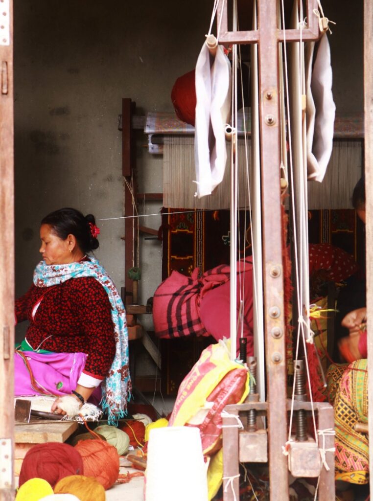 A local woman weaving yarn in Khokana.