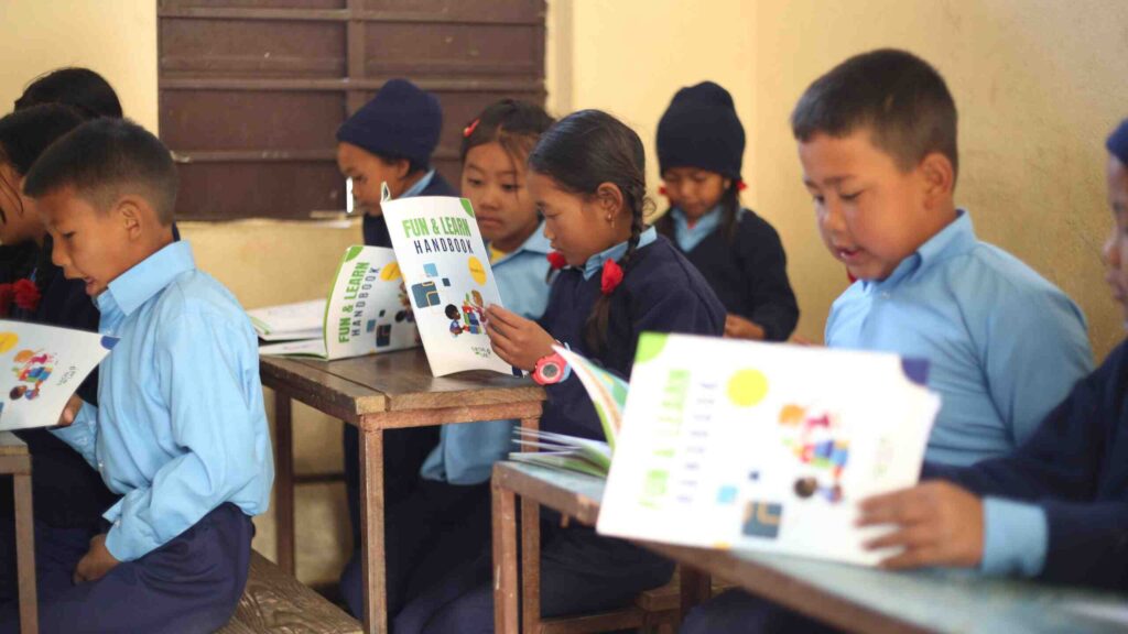 School support program children enjoying handbook